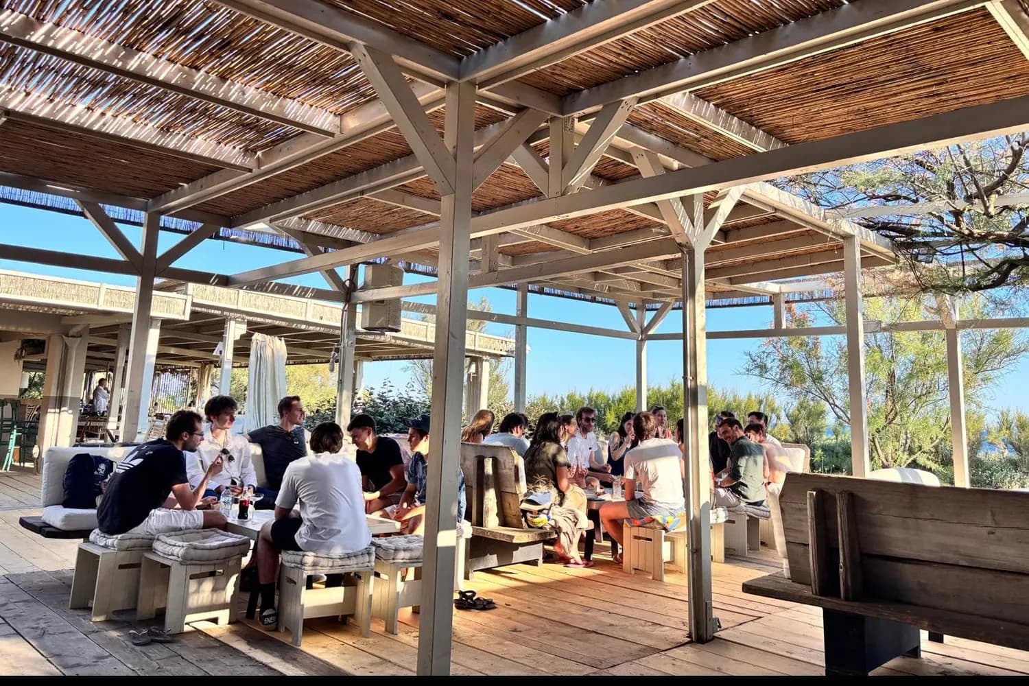 WeTransfer team at lunch on a beach terrace in Maremma
